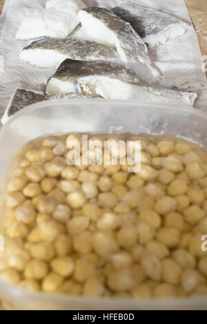 raw fillets of salted codfish and chickpeas in soaking Stock Photo