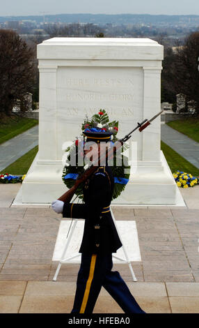 050324-N-0295M-252 Arlington, Va. (Mar. 24, 2005) Ð Tomb Guard Pfc. Michael Steiner marches behind the Tomb of the Unknowns during his 21-step march at Arlington National Cemetery, Va. Twenty-one steps was chosen because it symbolizes the highest military honor that can be bestowed, the 21-gun salute. The Tomb of the Unknowns is guarded 24 hours a day, 365 days a year, and in any weather by Tomb Guard sentinels. The sentinels, all volunteers, are considered to be the best of the 3rd U.S. Infantry (The Old Guard), headquartered at Fort Myer, Va. U.S. Navy photo by PhotographerÕs Mate 2nd Class  Stock Photo