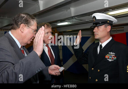 050324-N-8148A-027 San Diego, Calif. (Mar. 24, 2005) Ð Rep. Randy ÒDukeÓ Cunningham (R-CA), left, and Bill ÒIrishÓ Driscoll, center, take part in the reenlistment ceremony aboard USS Ronald Reagan (CVN 76), for Chief Operations Specialist Jack Thorpe. Cunningham and Driscoll became the first Naval Aviators to qualify as Aces in the Vietnam War when they shot down five North Vietnamese Migs between Jan. and May 1972. Cunningham became one of the most highly decorated U.S. Navy pilots in the Vietnam War. The first fighter ace of the war, he received the Navy Cross, two Silver Stars, fifteen Air  Stock Photo