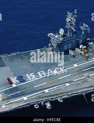 050419-N-4004O-001 Atlantic Ocean (April 19, 2005) - Crewmembers aboard the Nimitz-class aircraft carrier USS Dwight D. Eisenhower (CVN 69) spell out ÒIKE IS BACKÓ on the shipÕs flight deck, celebrating the carrierÕs successful return to the fleet following a four-year mid-life refueling complex overhaul. During the $2.5 billion overhaul, the 27-year-old aircraft carrier received state-of-the art equipment and technology, enabling her to serve for another 25 years. Eisenhower is currently underway conducting routine carrier operations in preparation for fulfilling her role in the NavyÕs Fleet  Stock Photo