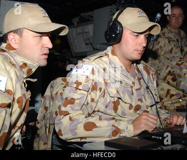 050425-N-1825E-068 Persian Gulf (April 25, 2005) - Royal Australian Navy (RAN) Able Seaman Combat Systems Operators Clint Baird and Mickael Renda operate the combat operations database aboard the guided missile cruiser USS Antietam (CG 54). Antietam is forward deployed to the Persian Gulf with about 20 RAN Sailors aboard as the flagstaff for Commander, Task Force Five Eight (CTF-58). This marks the first time since World War II an Australian coalition commander has led a task group in operations. Antietam is the first U.S Navy warship to operate as a task force flagship for a permanently embar Stock Photo