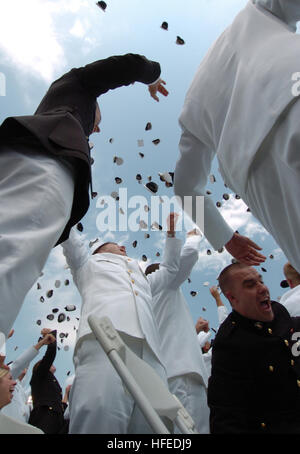 050527-N-9693M-005 Annapolis, Md. (May 27, 2005) - Newly commissioned officers celebrate their new positions by throwing their Midshipmen covers into the air as part of the U.S. Naval Academy class of 2005 Graduation and Commissioning Ceremony. The Òhat toss,Ó now a traditional ending to the ceremony, originated at the Naval Academy in 1912. This Òhat tossÓ has since become a symbolic and visual end to the four-year program. Nine hundred-seventy six Midshipmen graduated from the U.S. Naval Academy and became commissioned officers in the U.S. Military. President George W. Bush delivered the com Stock Photo