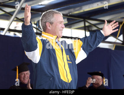 050527-N-5390M-206 Annapolis, Md. (May 27, 2005) Ð U.S. President George W. Bush tries on a Naval Academy windbreaker presented to him by a graduating Midshipman during the 2005 Naval Academy Graduation Ceremony, at the Navy Marine Corps Memorial Stadium. President George W. Bush delivered the commencement address and personally greeted each graduate during the ceremony. The men and women of the graduating class were sworn into the Navy as Ensigns or into the Marine Corps as Second Lieutenants. U.S. Navy photo by Ken Mierzejewski (RELEASED) US Navy 050527-N-5390M-206 U.S. President George W. B