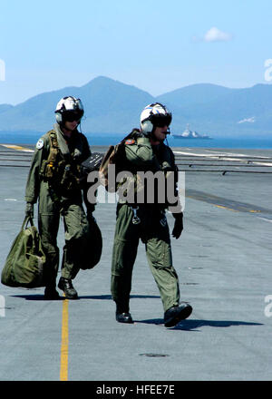 050111-N-6817C-167 Indian Ocean (Jan. 11, 2005) Ð Pilots, assigned to the ÒGolden FalconsÓ of Helicopter Anti-Submarine Squadron Two (HS-2), walk toward their SH-60F Seahawk on the flight deck aboard USS Abraham Lincoln (CVN 72). Helicopters assigned to Carrier Air Wing Two (CVW-2) and Sailors from USS Abraham Lincoln (CVN 72) are supporting Operation Unified Assistance, the humanitarian operation effort in the wake of the Tsunami that struck South East Asia. The Abraham Lincoln Carrier Strike Group is currently operating in the Indian Ocean off the waters of Indonesia and Thailand. U.S. Navy  Stock Photo