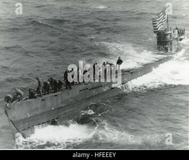 030205-N-0000X-001 Washington Navy Yard (Feb. 5, 2002) -- A boarding party from the USS Pillsbury (DE 133) works to secure a tow line to the newly captured German U-boat U-505 on Jun 4, 1944.  Note the large U.S. flag flying from the periscope. While the U-505 has been on exhibit at the Museum of Science and Industry in Chicago since 1954, this periscope has been missing from the submarine since the Navy removed it for testing after World War II. The two were recently reunited when the periscope was discovered during the demolition of the NavyÕs old Artic Submarine Laboratory in Point Loma, Ca Stock Photo