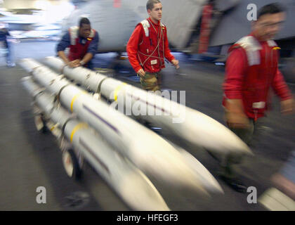 030312-N-3235P-501 The Mediterranean Sea (Mar. 12, 2003) -- Aviation Ordnancemen assigned to weapons department, transfer AIM-7 Sparrow radar-guided, air-to-air missiles across the shipÕs hangar bay aboard the aircraft carrier USS Harry S. Truman (CVN 75).  The missiles will be loaded onto a weapons elevator for transport to aircraft on the flight deck.  Truman and Carrier Air Wing Three (CVW-3) are currently on deployment conducting missions in support of Operation Enduring Freedom.  U. S. Navy photo by Photographer's Mate 1st Class Michael W. Pendergrass.  (RELEASED) US Navy 030312-N-3235P-5 Stock Photo