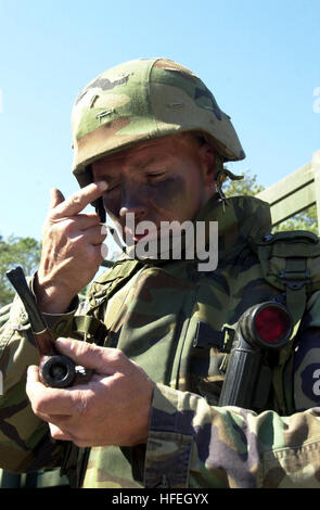 030402-N-9310B-001 Camp LeJeune, N.C. (Apr. 2, 2003) -- Senior Chief Equipment Operator Joe Ott, assigned to Naval Mobile Construction Battalion Twenty Three (NMCB-23) puts on his battle paint prior to deploying for a field exercise.  NMCB-23 is participating in exercise Sharp Wedge 2003, an annual exercise designed to test the military and construction skills of reserve units in the Naval Construction Force to ensure their readiness in a contingency environment.  U.S. Navy photo by Journalist 1st Class Brigette A. Barnes.  (RELEASED) US Navy 030402-N-9310B-001 Senior Chief Equipment Operator  Stock Photo