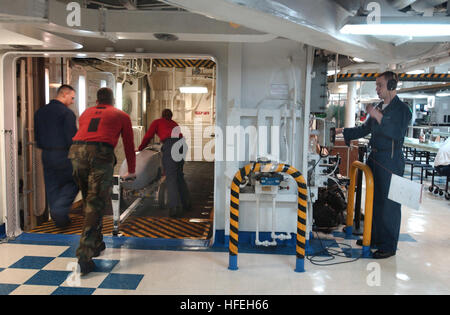 030322-N-7781D-048 The Arabian Gulf (Mar. 22, 2003) -- Aviation Ordnancemen transfer ordnance through the mess deck elevators en route to the flight deck aboard USS Harry S. Truman (CVN 75) for use in missions over Iraq.  Truman is deployed in support of Operation Iraqi Freedom. Operation Iraqi Freedom is the multi-national coalition effort to liberate the Iraqi people, eliminate Iraq's weapons of mass destruction, and end the regime of Saddam Hussein.  U.S. Navy photo by Photographer's Mate 2nd Class Andrea Decanini.  (RELEASED) US Navy 030322-N-7781D-048 Aviation Ordnancemen transfer ordnanc Stock Photo