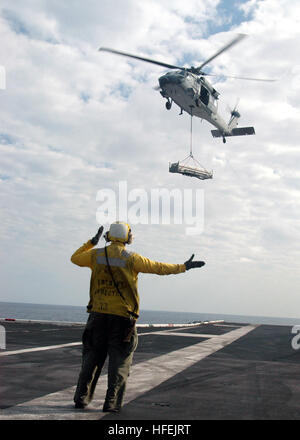 040423-N-4565G-001  Atlantic Ocean (Apr. 23, 2004) - Aviation BoatswainÕs Mate 3rd Class Ricardo Campos directs an MH-60S ÒKnighthawkÓ assigned to the ÒTridentsÓ of Helicopter Anti-Submarine Squadron Three (HS-3) on to the fight deck aboard USS John F. Kennedy (CV67). The conventional powered aircraft carrier conducted an underway replenishment with the fast combat support ship USS Seattle (AOE-3) and a vertical replenishment with the USS Enterprise (CVN-65) in final preparations for a scheduled six-month deployment to the Mediterranean Sea. U.S. Navy photo by PhotographerÕs Mate Airman Tommy  Stock Photo