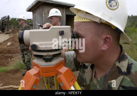 030428-N-4936C-119  Naval Station Guantanamo Bay, Cuba (Apr. 28, 2003) -- Chief Equipment Operator Chris Walaszek uses a dumpy level to survey the topography of the bus turn across the street from Camp Delta at Naval Station Guantanamo Bay.  Chief Walaszek is assigned to Naval Mobile Construction Battalion Twenty One (NMCB-21), a reserve unit based in Lakehurst, N.J., deployed to Guantanamo Bay for one year.  U.S. Navy photo by Journalist Seaman David P. Coleman.  (RELEASED) US Navy 030428-N-4936C-119 Chief Equipment Operator Chris Walaszek uses a dumpy level to survey the topography Stock Photo