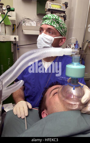 030513-N-1577S-001 Central Command Area of Responsibility (May 13, 2003) -- Lt. Cmdr. Joe Casey, ShipÕs Anesthetist, trains on anesthetic procedures with Hospital Corpsman 3rd Class Eric Wichman aboard USS Nimitz (CVN 68).   The Nimitz Carrier Strike Group and Carrier Air Wing Eleven (CVW-11) are deployed in support of Operation Iraqi Freedom, the multi-national coalition effort to liberate the Iraqi people, eliminate IraqÕs weapons of mass destruction, and end the regime of Saddam Hussein.  U.S. Navy photo by PhotographerÕs Mate Airman Timothy F. Sosa.  (RELEASED) US Navy 030513-N-1577S-001 L Stock Photo