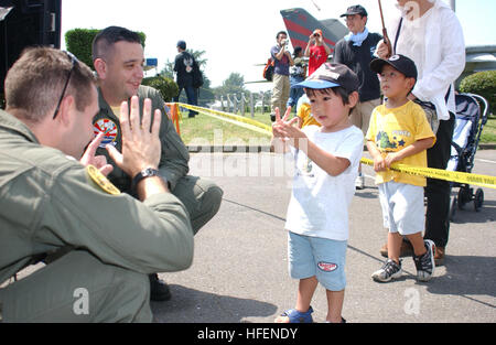 030823-N-7805K-001  Atsugi, Japan (Aug. 23, 2003) -- Lt. j.g. Terrence Mcadoo, assigned to the ÒChargersÓ of Helicopter Anti-Submarine Squadron Fourteen (HS-14), asks, 'How old are you?'  Crewmembers assigned to HS-14 were on hand along with one of the squadrons SH-60 Seahawk helicopters, during the annual American Festival aboard Naval Air Facility Atsugi, Japan.   U.S. Navy photo by PhotographerÕs Mate 3rd Class Shaun Knittel.  (RELEASED) US Navy 030823-N-7805K-001 Lt. j.g. Terrence Mcadoo, assigned to the Chargers of Helicopter Anti-Submarine Squadron Fourteen (HS-14), asks, How old are you Stock Photo