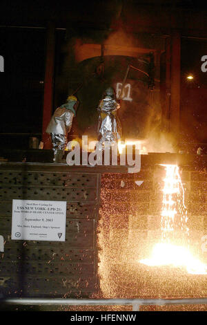 030910-N-7542D-254 Amite, La. (Sept. 10, 2003) -- Workers from the Amite foundry pour molten steel recycled from the World Trade Center, into the mold of the bow stem of the Amphibious Transport Dock ship USS New York (LPD 21).  About 24-tons of steel was salvaged from the World Trade Center, which was destroyed in the terrorist attacks of Sept. 11, 2001.  About 10-percent of the steel was lost when the foundry superheated the 48,780 lbs. of steel to 2,850 degrees Fahrenheit. U.S. Navy photo by Photographer's Mate 1st Class Dean Dunwody.  (RELEASED) US Navy 030910-N-7542D-254 Workers from the  Stock Photo