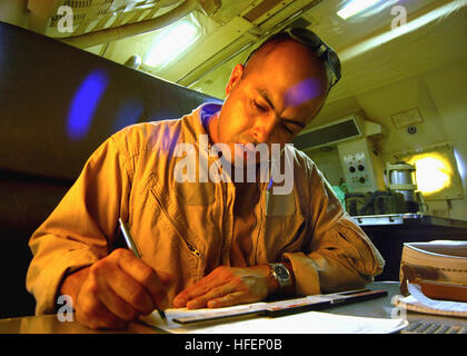 030920-N-3879H-002 Manama, Bahrain (Sept. 20, 2003) -- Aviation Machinist's Mate 1st Class  Eric Martinez performs pre-flight calculations before a P3-C Orion, belonging to the Patrol Squadron 40 'Fighting Marlins,'  departs for a regular mission.  Martinez is assigned to the squadron Combat Aircrew Crew 10, deployed to the 5th Fleet in support of Operations Iraqi Freedom and Enduring Freedom.  U.S. Navy photo by JO1 Dennis J. Herring.  (RELEASED) US Navy 030920-N-3879H-002 pre-flight calculations before a P3-C Orion, belonging to the Patrol Squadron 40 Stock Photo