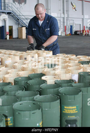050415-N-3122S-002 Okinawa, Japan (Apr. 15, 2005) - Aviation Ordnanceman 3rd Class Martin Hardwick, assigned to the 'Tigers' of Patrol Squadron Eight (VP-8), aligns sonobuoy tubes prior to loading. Sonobuoys are search stores carried on the P-3C Orion and are loaded into the underside of the rear fuselage of the aircraft. More are carried internally and can be launched out of three pressurized chutes or the free fall chute. U.S. Navy photo by PhotographerÕs Mate 3rd Class Shannon R. Smith (RELEASED) US Navy 050415-N-3122S-002 Aviation Ordnanceman 3rd Class Martin Hardwick, assigned to the Tige Stock Photo