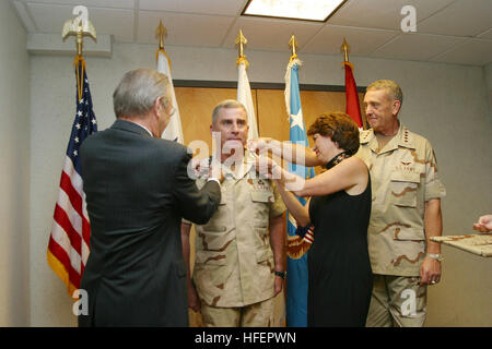 030707-N-5891B-003 Tampa, Fla. (Jul. 7, 2003) -- The Honorable Donald Rumsfeld, Secretary of Defense, and Gen. John P. AbizaidÕs wife, along with outgoing Commander United States Central Command (USCENTCOM) Gen. Tommy R. Franks pin on Gen. AbizaidÕs forth star.  Gen. Abizaid was promoted before assuming command of CENTCOM, which covers 25 countries of the Middle East, Central Asia, and Horn of Africa.  U.S. Navy photo by Petty Officer 1st Class Gary P. Bonaccorso.  (RELEASED) US Navy 030707-N-5891B-003 The Honorable Donald Rumsfeld, Secretary of Defense, and Gen. John P. Abizaid%%5Ersquo,s wif Stock Photo