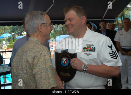 040222-N-0493B-001 Singapore (Feb. 22, 2004) Ð The Honorable Gordon R. England, Secretary of the Navy, congratulates Quartermaster 1st Class Chris McCoy on his selection as Commander, Logistics Group Western Pacific's Sailor of the Year (SOY). Secretary England presented the award to Petty Officer McCoy during a visit with Sailors and families to thank them for their continued service.  Secretary England is in Singapore to participate in the Asian Aerospace 2004 air show. U.S. Navy photo by Lt. Chuck Bell. (RELEASED) US Navy 040222-N-0493B-001 The Honorable Gordon R. England, Secretary of the  Stock Photo