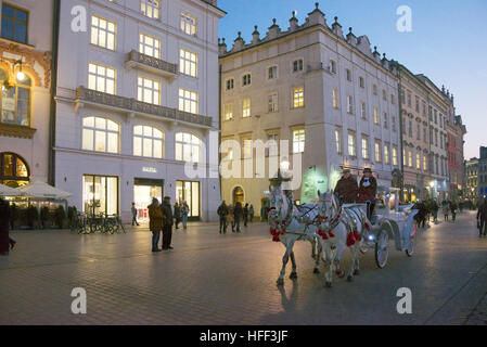 Horse-drawn coach Market Square at night Krakow Poland Stock Photo