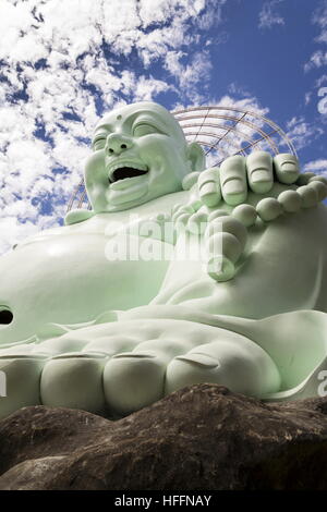 Statue of sitting and smiling Laughing Buddha statue near Linh An Tu Temple, Dalat, Vietnam Stock Photo