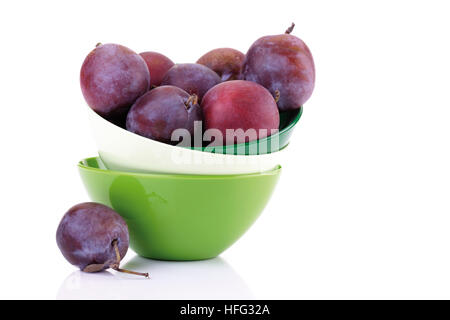 Plums in a colourful stack of bowls Stock Photo