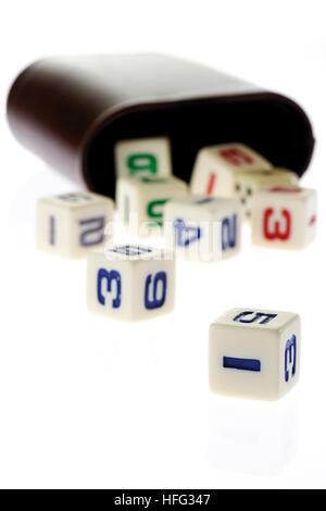 Number dice tumbling out of a dice shaker Stock Photo