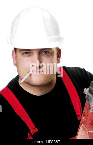 Construction worker wearing a white hardhat smoking a cigarette Stock Photo