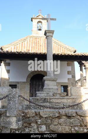 Cross Stone in front a Hermitage in  Candelario, a  village in the province of Salamanca, Spain. Stock Photo