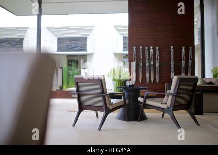 tropical furniture two low chairs coffee table interior design Alila Uluwatu Bali modern classic Stock Photo