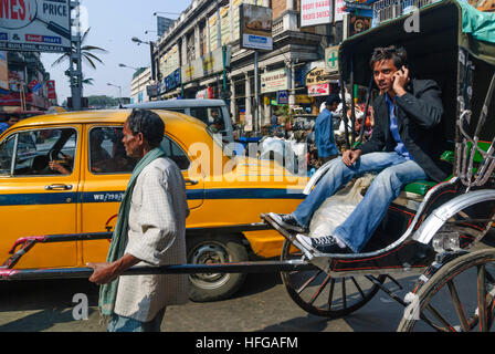 Kolkata (Calcutta, Kalkutta): pulled Rickshaw, man with mobile phone as passenger, West Bengal, Westbengalen, India Stock Photo