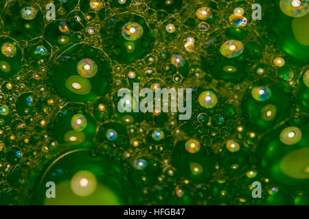 Green Bubbles made up of a mixture of oil, water and washing up liquid Stock Photo