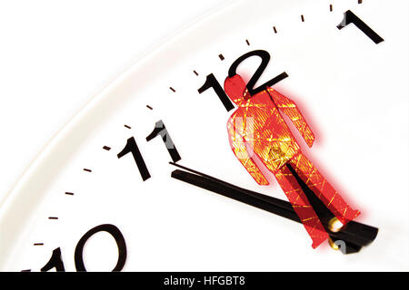 Clock showing five-to-twelve and superimposed red traffic light figure Stock Photo