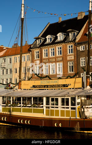 Denmark, Copenhagen, Oranje at Svenborg restaurant boat moored beside Nyhavn Quay Stock Photo