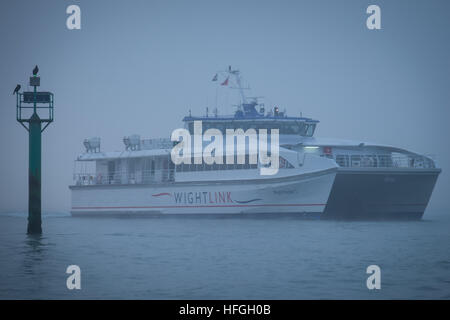 The Wighlink catamaran, Wight Ryde 1 entering Portsmouth Harbour on a foggy winter morning Stock Photo
