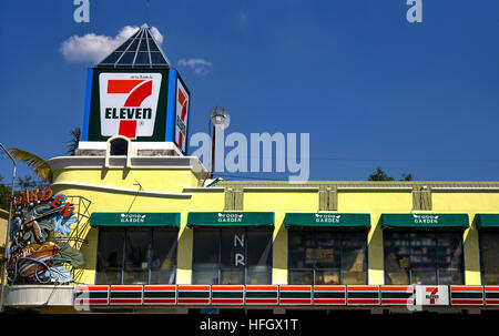 7-eleven convenience store against a deep blue summer sky. Thailand S. E. Asia. Asian 7- 11 Stock Photo