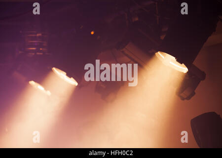 Powerful spot lights on smoke background, stage illumination Stock Photo