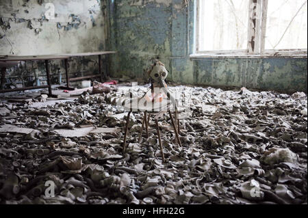 Beijing, China. 19th Apr, 2016. Photo taken on April 19, 2016 shows a doll with a gas mask in a deserted school in Pripyat city near Chernobyl, Ukraine. © Dai Tianfang/Xinhua/Alamy Live News Stock Photo
