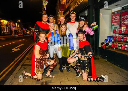 Bridport, Dorset, UK.   31st December 2016.  New Years revellers don fancy dress to see in the New Year at Bridport in Dorset.  A group of Romans and Jockeys. Picture: Graham Hunt/Alamy Live News. Stock Photo