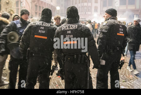 Police officers secure the Roemerberg in Frankfurt am Main, Germany, 31 December 2016. This year a large force of police officers secured the event. An additional separated security area was also erected that could accommodate 30,000 people following a security check upon entry. Photo: Boris Roessler/dpa Stock Photo