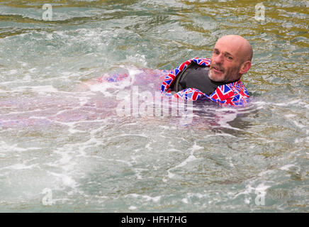 Poole, Dorset, UK. 1st Jan, 2017. Hundreds turn out to watch the New Years Day Bath Tub Race. A variety of unusual craft take to the water to race, having fun throwing eggs and flour, firing water cannons and capsizing competing craft. Man wearing Union Jack suit in water © Carolyn Jenkins/Alamy Live News Stock Photo