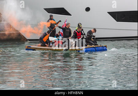 Poole, Dorset, UK. 1st January, 2017. Hundreds turn out to watch the New Years Day Bath Tub Race. A variety of unusual craft take to the water to race, having fun throwing eggs and flour, firing water cannons and capsizing competing craft. Stock Photo