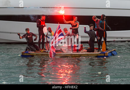 Poole, Dorset, UK. 1st January, 2017. Hundreds turn out to watch the New Years Day Bath Tub Race. A variety of unusual craft take to the water to race, having fun throwing eggs and flour, firing water cannons and capsizing competing craft. Stock Photo