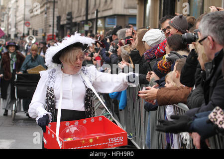 London, UK. 1st January 2017. A performer from the City of Westminster hand out sweets to spectators during the  New Year's Day Parade in London on January 1, 2017. About 8,000 performers  from across the globe took part in the 2017 New Years Parade, that was themed 'Lights, Camera, Action' . The parade is to start at 12pm, and follow the usual route from Green Park Tube station and end at3.30pm in Parliament Square, via Piccadilly Circus, Lower Regent Street, Pall Mall, Trafalgar Square and Whitehall. © David Mbiyu/Alamy Live News Stock Photo