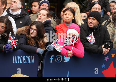 London, UK. 1st January 2017. Spectators seen waving mini Union Jacks along the New Year's Day Parade in London on January 1, 2017.  About 8,000 performers  from across the globe took part in the 2017 New Years Parade, that was themed 'Lights, Camera, Action' . The parade is to start at 12pm, and follow the usual route from Green Park Tube station and end at3.30pm in Parliament Square, via Piccadilly Circus, Lower Regent Street, Pall Mall, Trafalgar Square and Whitehall. © David Mbiyu/Alamy Live News Stock Photo