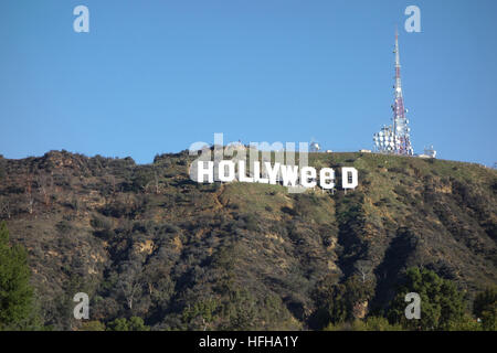 Hollywood, USA. 1st January 2017. The iconic Hollywood Sign was altered by pranksters to read 'Hollyweed'.  Residents nearby the sign awoke to this view on New Year's Day. The iconic sign was similarly altered once before on Jan. 1, 1976. Credit: Robert Landau/Alamy Live News Stock Photo