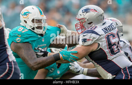 Miami Gardens, Florida, USA. 1st Jan, 2017. Miami Dolphins defensive tackle Jordan Phillips (97) battles New England Patriots center David Andrews (60) at Hard Rock Stadium in Miami Gardens, Florida on January 1, 2017. © Allen Eyestone/The Palm Beach Post/ZUMA Wire/Alamy Live News Stock Photo