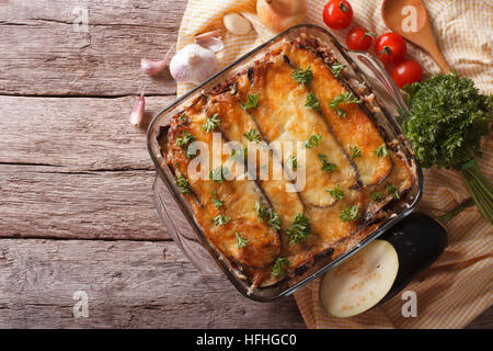 Greek moussaka in baking dish with the ingredients on the table. horizontal view from above Stock Photo