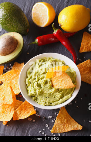 hot sauce guacamole, nachos chips close-up and ingredients. vertical Stock Photo