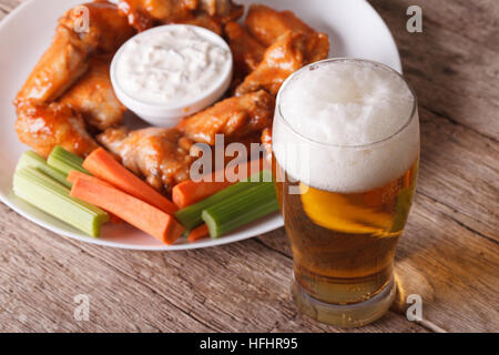 buffalo hot wings with white sauce and beer on the table close-up horizontal Stock Photo