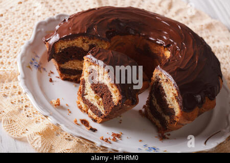 delicious marble cake with chocolate frosting sliced close-up on a plate. horizontal Stock Photo