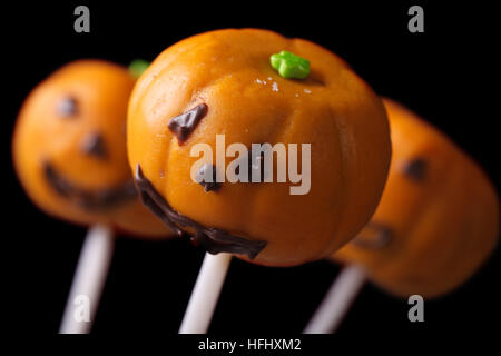 Halloween pumpkin cake pops isolated on a black background. horizontal Stock Photo